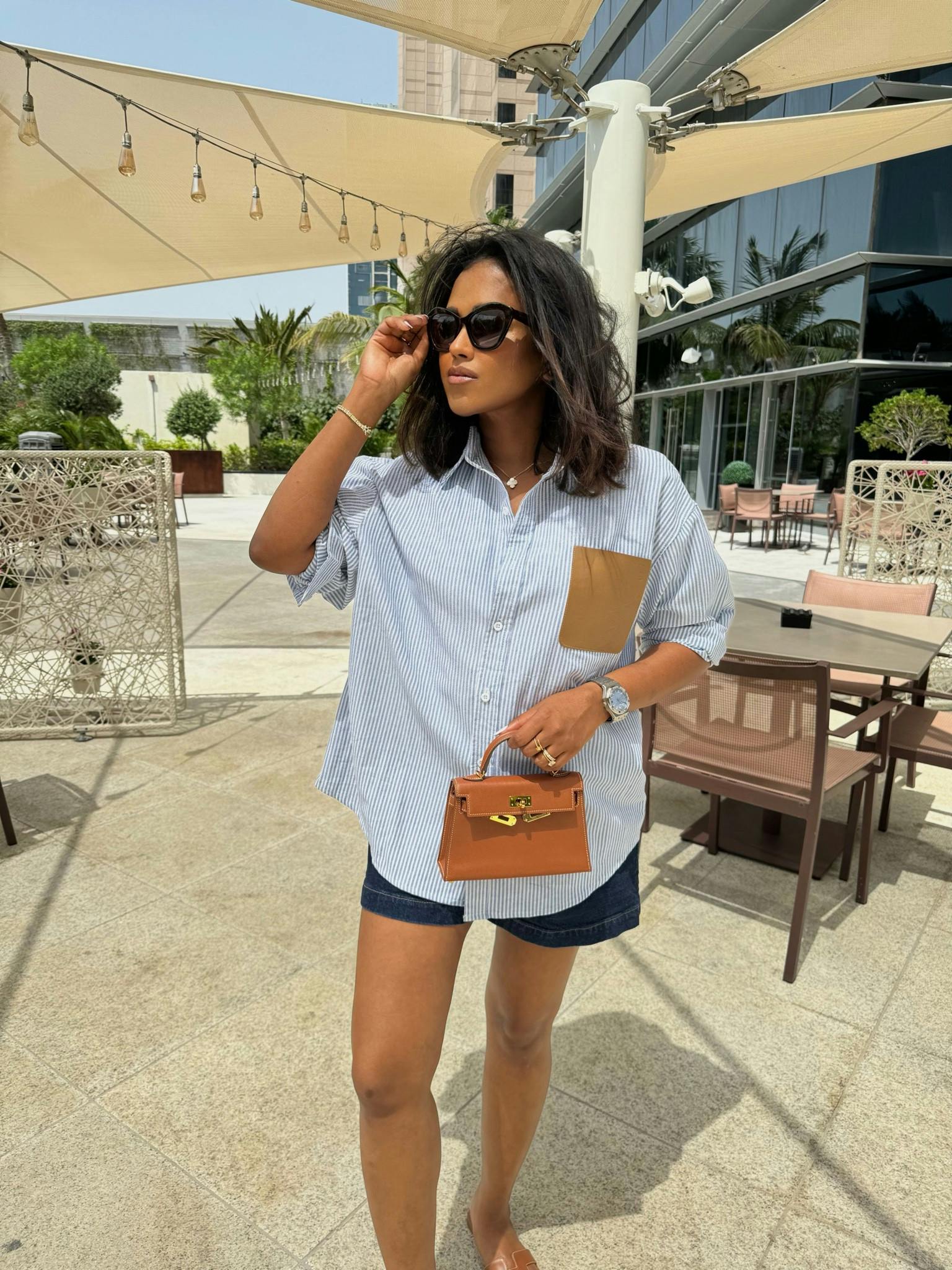 Casual outfit, Loewe, Oversized shirt, summer outfit, shorts, Other Stories, Denim shorts, Dubai outfit, summer shorts, Hermes Mini Kelly, brown sandals, Orans